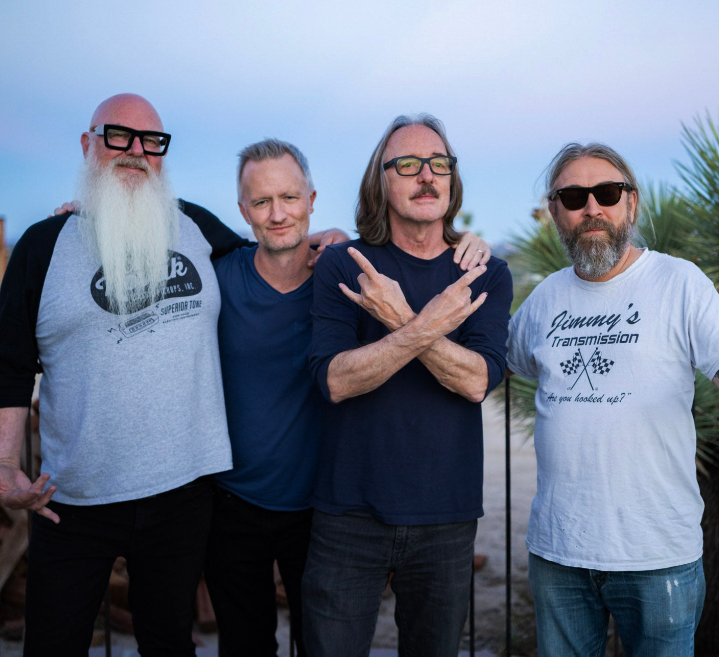 David Catching, Ryan Gruss, Butch Vig, and Bingo Richey standing together outside at dusk